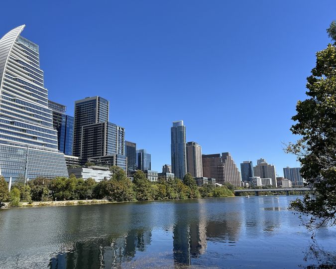 Downtown Austin skyline reflected in Lady Bird Lake on a clear day