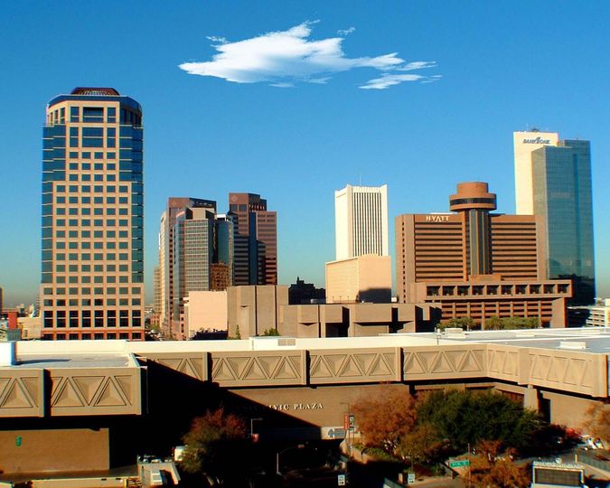 Downtown Phoenix high-rises under a bright blue sky